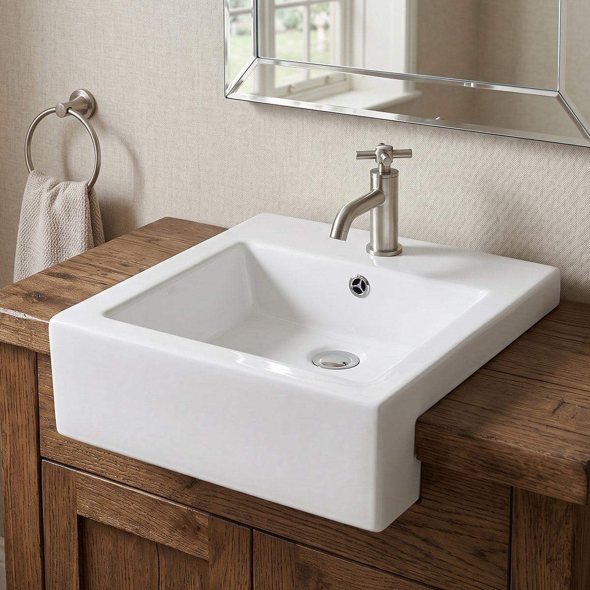 White compact rectangular ceramic vessel sink mounted above-counter on a wood vanity with a brushed nickel single-hole faucet