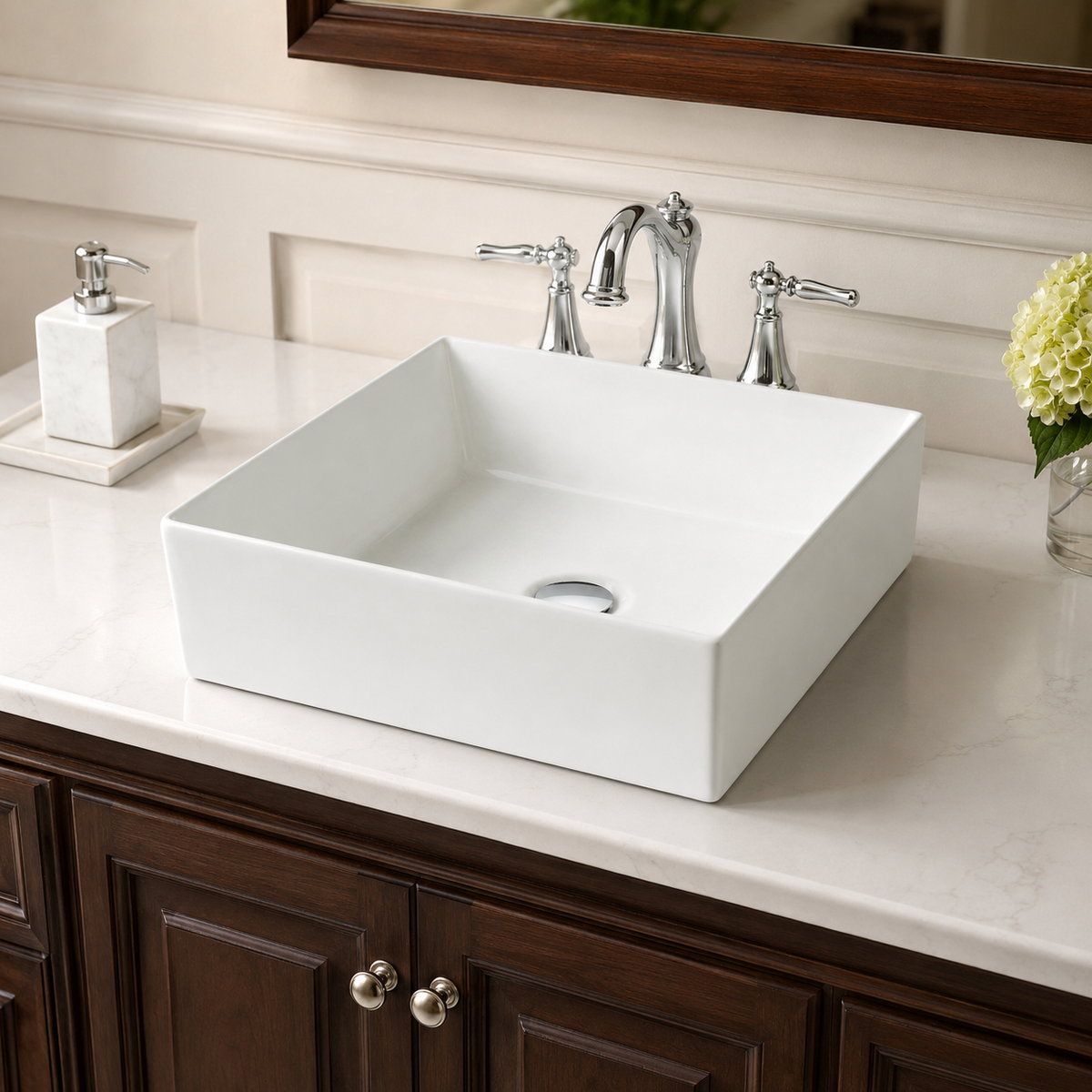 White 16 inch square ceramic vessel sink on a bathroom vanity, paired with a deck-mounted chrome faucet behind the basin