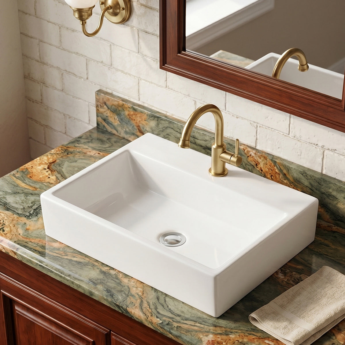 White rectangular ceramic vessel sink installed on a green and gold stone vanity with a brushed gold faucet