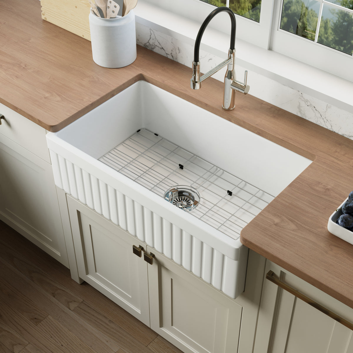 Top view of the single-bowl fireclay farmhouse sink with protective stainless bottom grid — SANIKB SN3320T
