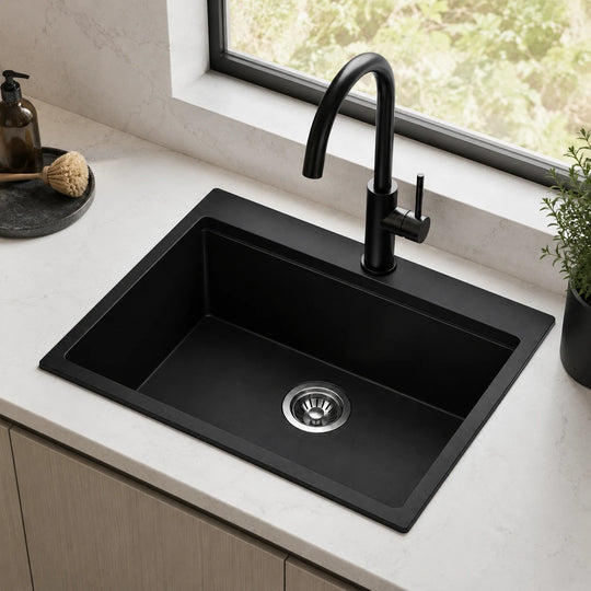 Black drop in quartz composite sink installed in a styled kitchen — lifestyle scene, SANIKB SN5855.