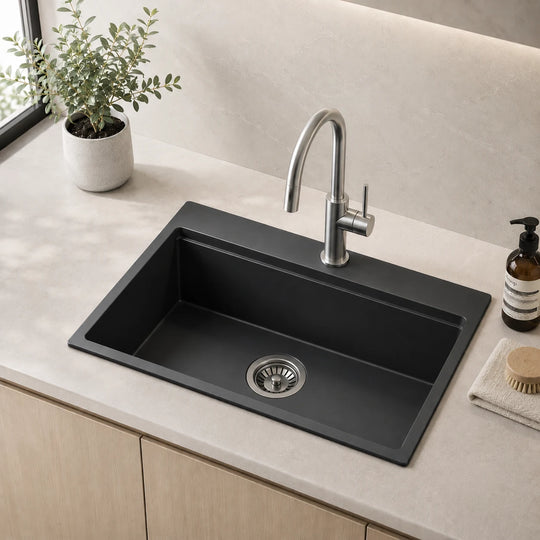 Black quartz composite kitchen sink with drainboard installed in a styled kitchen — lifestyle scene, SANIKB SN8549B.