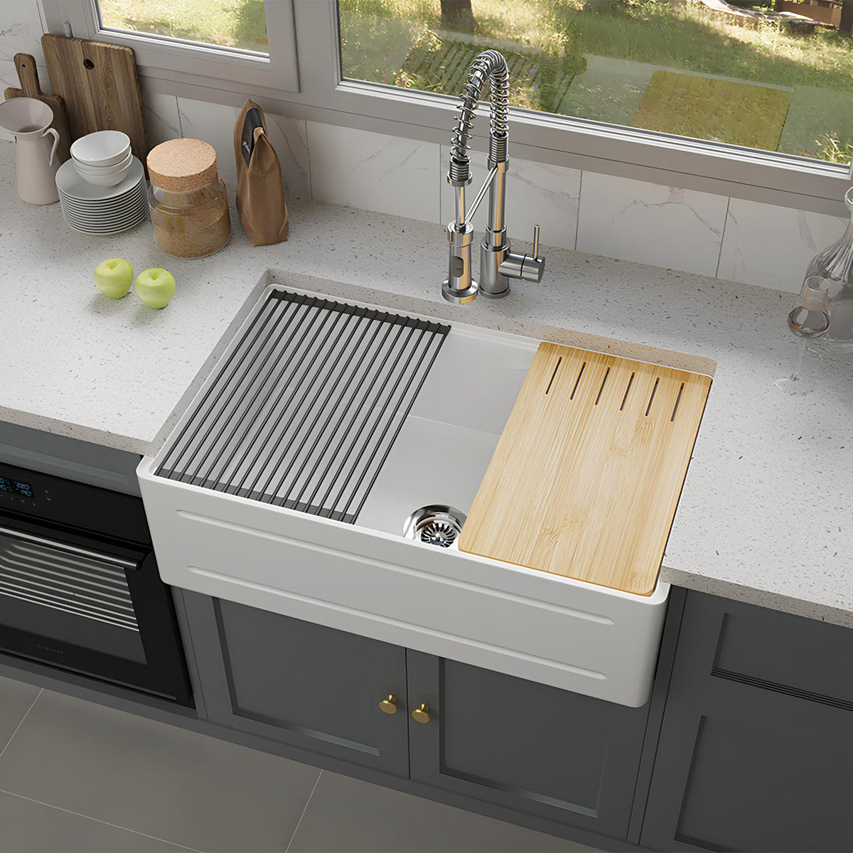 Modern kitchen with a white farmhouse sink, wooden cutting board, and gray cabinets.