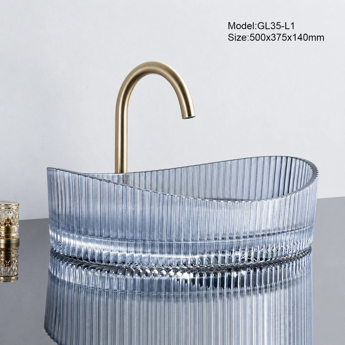 Blue tinted fluted oval glass vessel sink with gold faucet, 500mm above-counter basin
