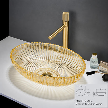 Clear glass oval vessel sink with gold rim and gold faucet, 510mm bowl