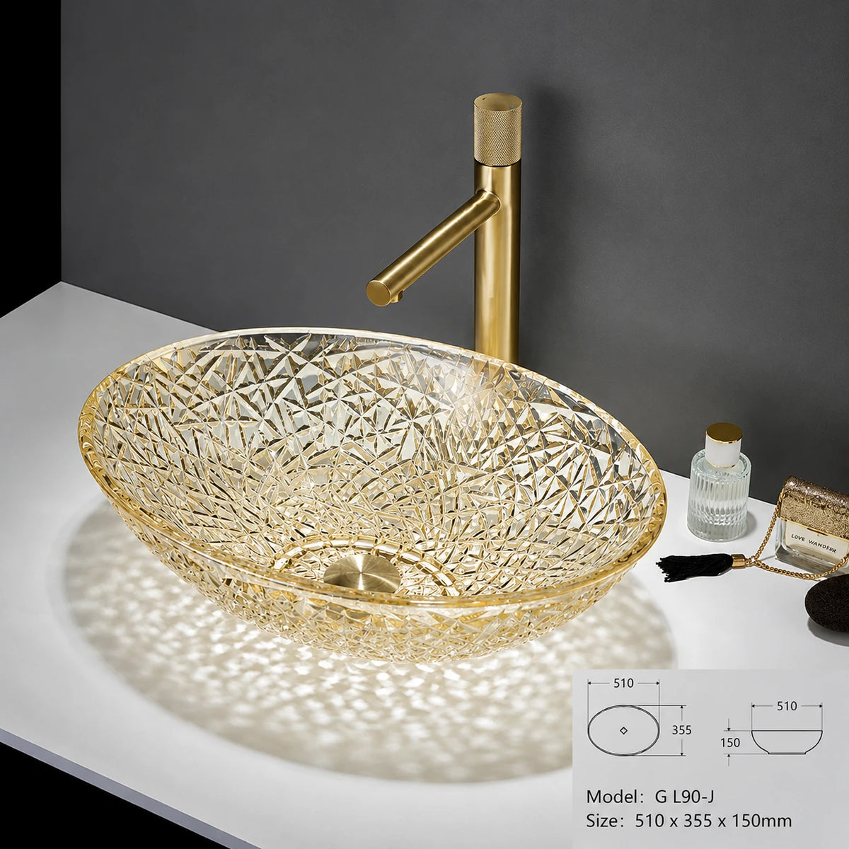 Clear gold-rimmed faceted glass vessel sink with gold faucet, oval bowl