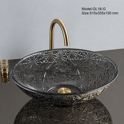 Grey faceted glass vessel sink with gold faucet, oval 510mm starburst-cut bowl