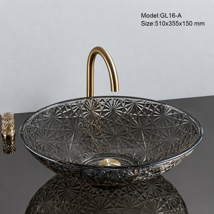 Smoke grey faceted glass vessel sink with gold faucet, oval 510mm starburst-cut bowl