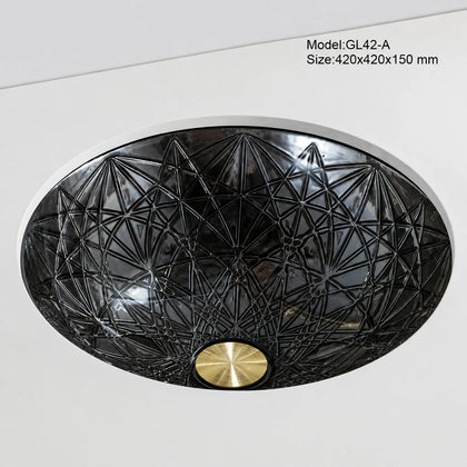 Undermount smoke grey faceted glass basin, round 420mm starburst-cut bowl installed below counter