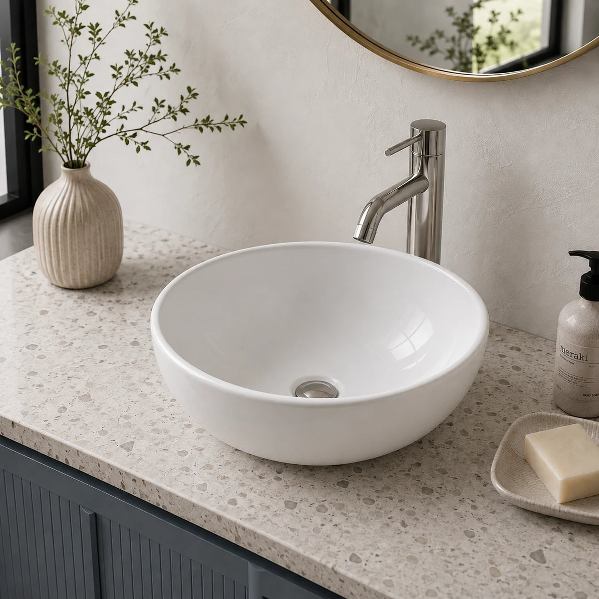 Small round ceramic vessel sink installed in a styled bathroom — lifestyle scene, SANIKB SN129.