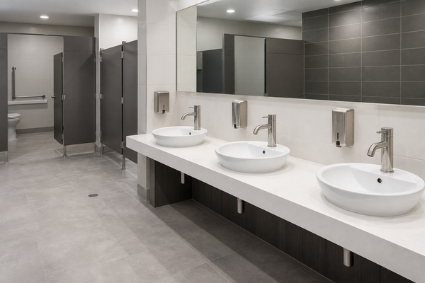 Multi-station commercial restroom with coordinated basins and faucets