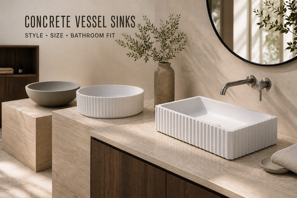 Three concrete vessel basins—two round and one rectangular—displayed across a warm-stone bathroom vanity.