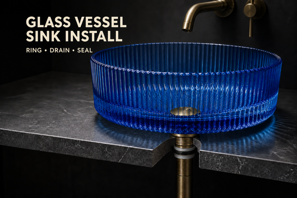 Cobalt-blue fluted glass vessel sink on a dark countertop cutaway, with its drain and tailpiece visible below.