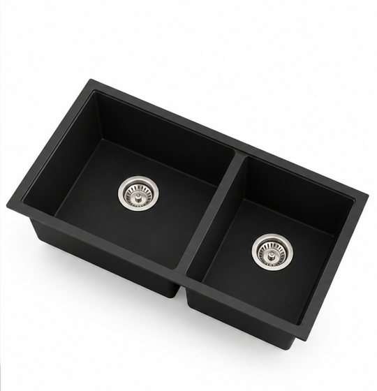 Black double bowl quartz composite kitchen sink option with divided rectangular basins and drain fittings