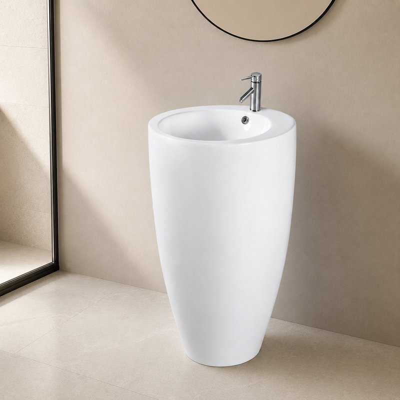 White round bowl ceramic pedestal sink installed in a corner bathroom with a chrome single-hole faucet and round mirror