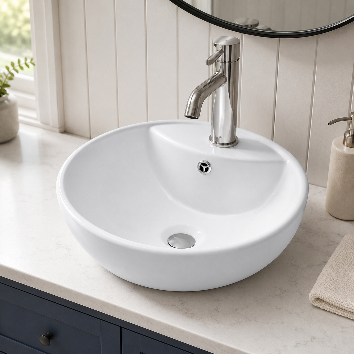 White 18 inch round ceramic vessel sink installed on a vanity top with a single-hole vessel faucet in a modern bathroom