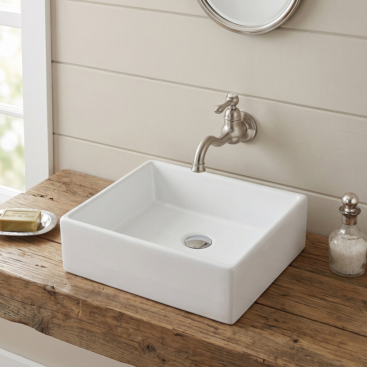 White 20 inch rectangular ceramic vessel sink installed above-counter on a wood vanity with a wall-mounted faucet