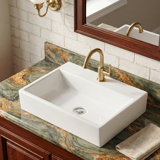 White rectangular ceramic vessel sink installed on a green and gold stone vanity with a brushed gold faucet