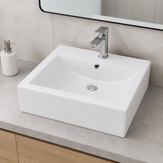 White rectangular ceramic vessel sink with soft-curve basin on a stone vanity top with a tall single-hole faucet