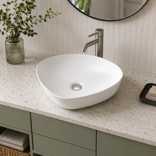 Asymmetrical ceramic vessel sink installed in a styled bathroom — lifestyle scene, SANIKB SN175.