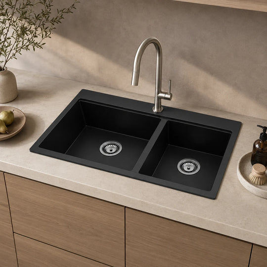Black double bowl quartz composite sink installed in a styled kitchen — lifestyle scene, SANIKB SN8350.