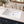 Ceramic undermount bathroom sink installed in a styled bathroom — lifestyle scene, SANIKB SN018.