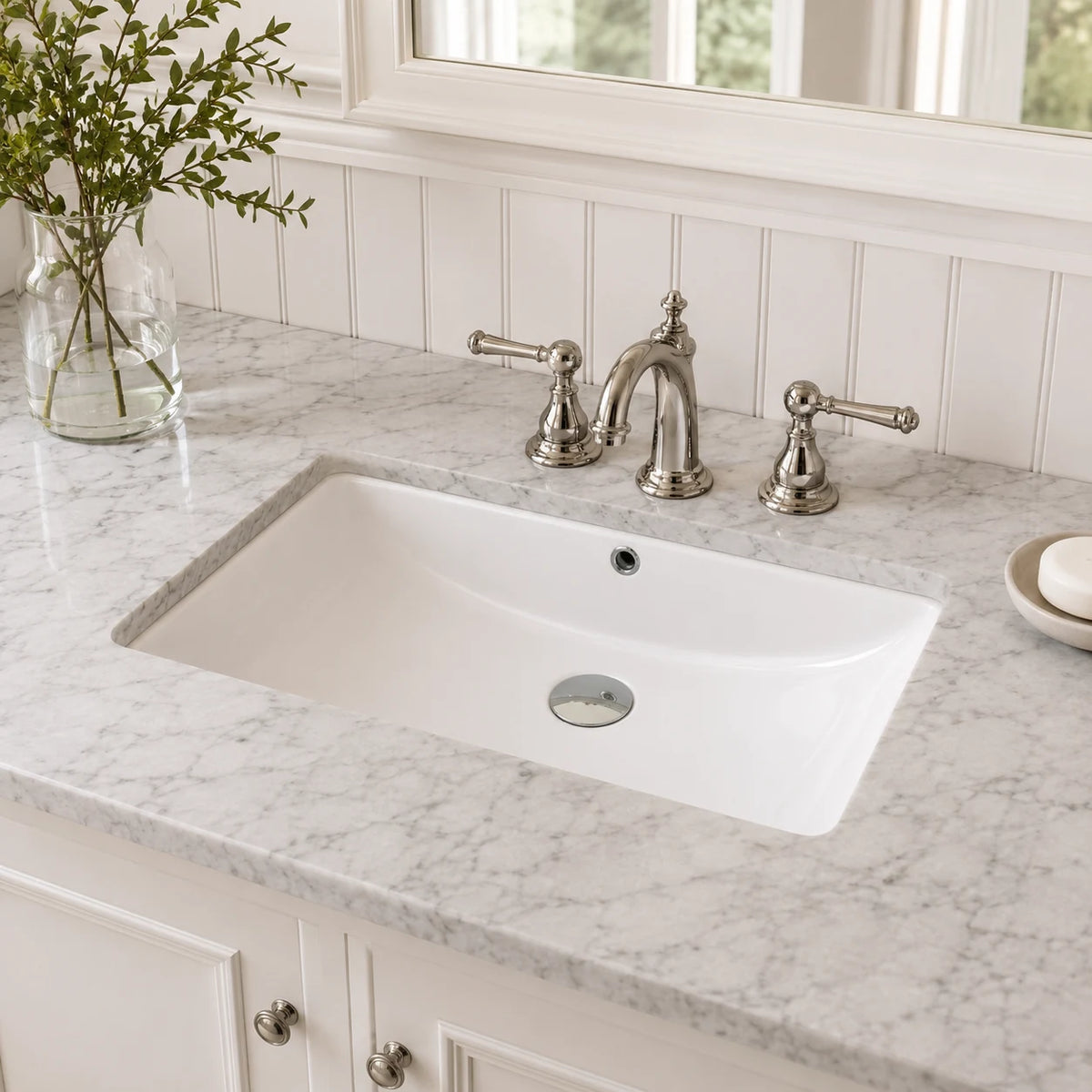 Ceramic undermount bathroom sink installed in a styled bathroom — lifestyle scene, SANIKB SN025.