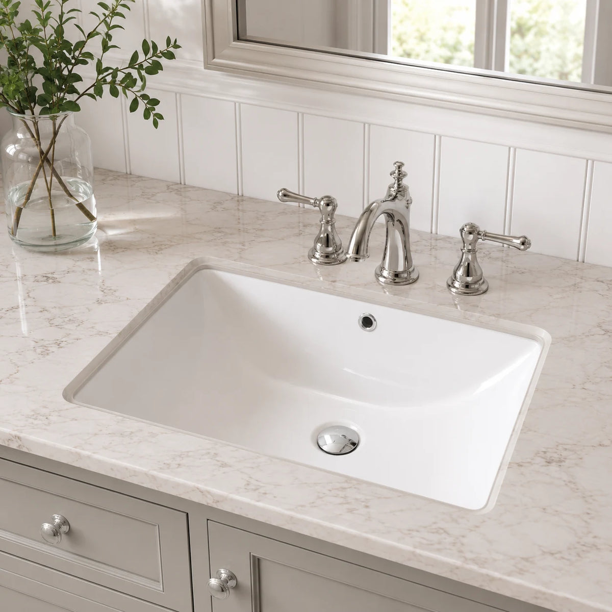 Ceramic undermount bathroom sink installed in a styled bathroom — lifestyle scene, SANIKB SN026.