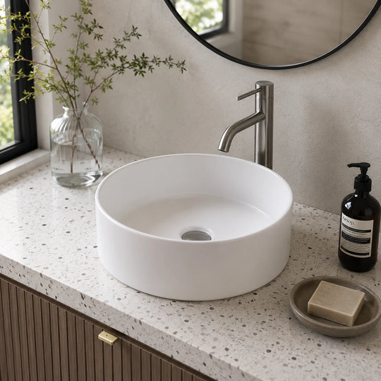 537c cylindrical round ceramic vessel sink installed in a styled bathroom — lifestyle scene, SANIKB SN134-537C.