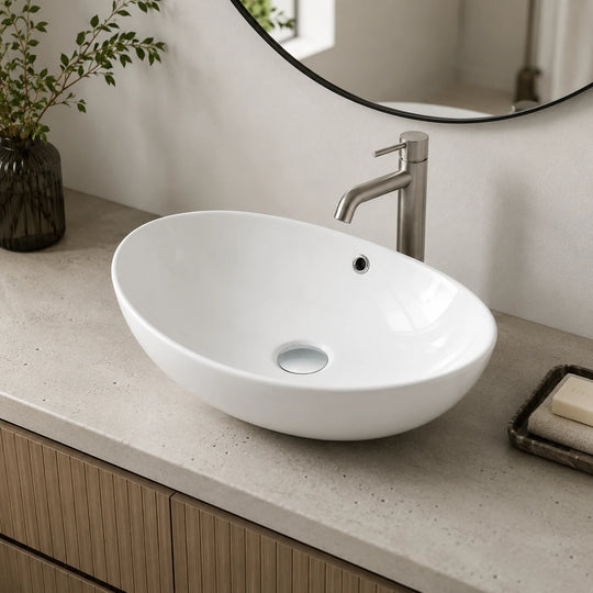 Oval ceramic vessel sink installed in a styled bathroom — lifestyle scene, SANIKB SN188.