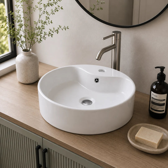 Oval ceramic vessel sink with faucet deck installed in a styled bathroom — lifestyle scene, SANIKB SN140-1101.