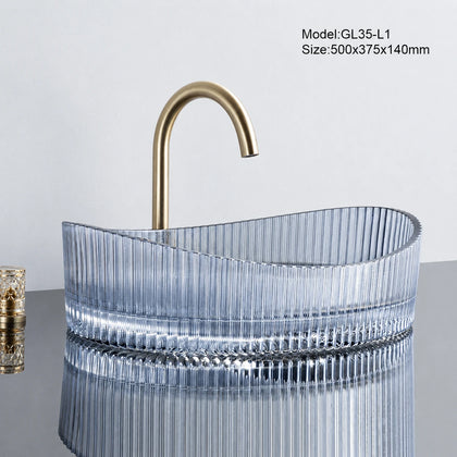 Blue tinted fluted oval glass vessel sink with gold faucet, 500mm above-counter basin