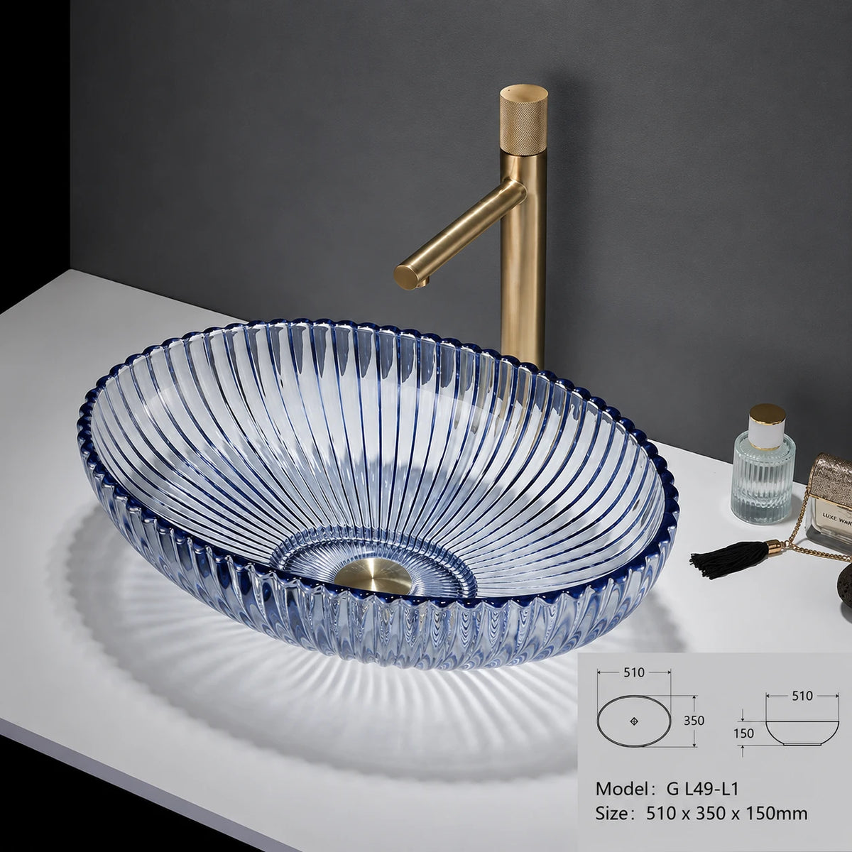 Clear glass oval vessel sink with blue rim and gold faucet, 510mm bowl