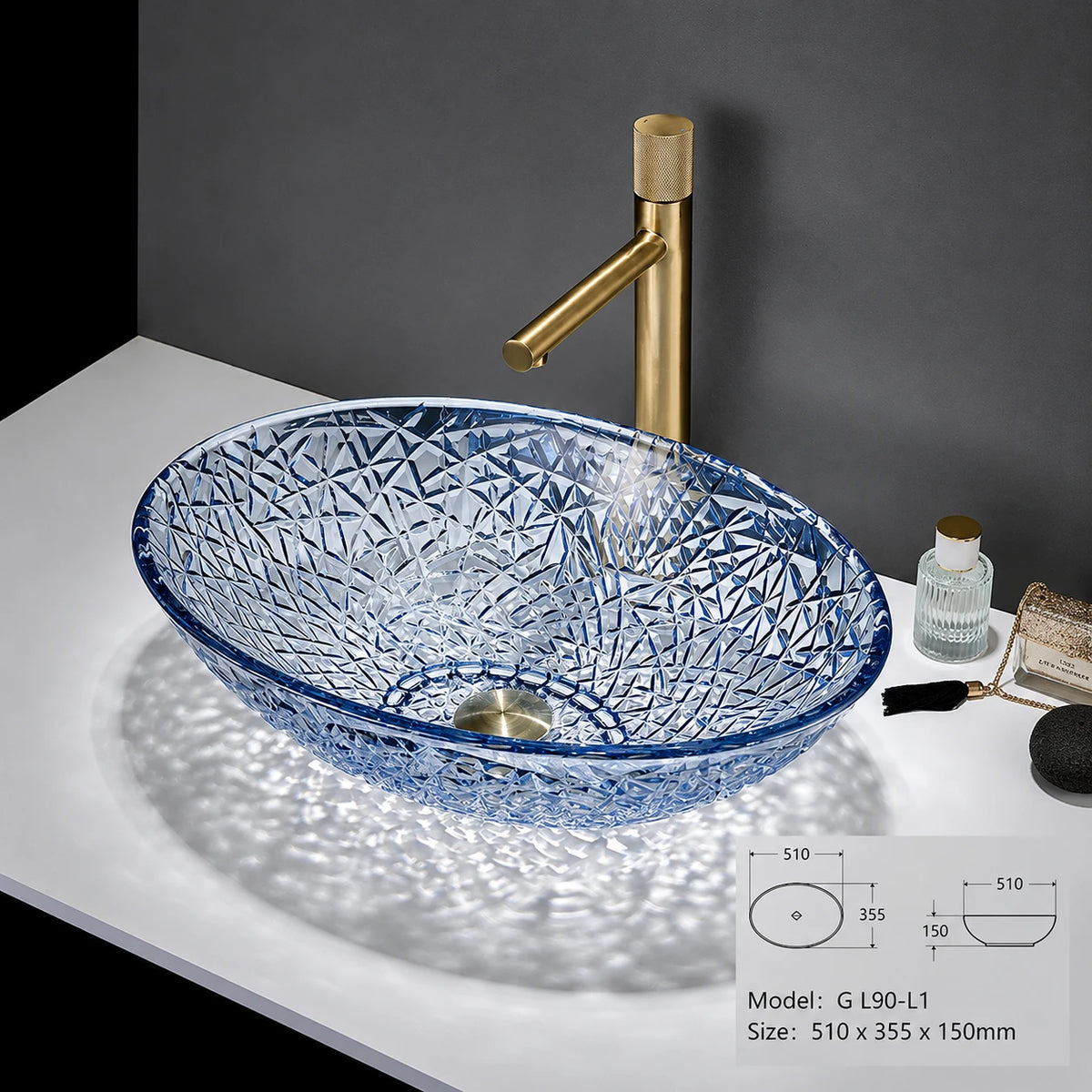 Clear blue-rimmed faceted glass vessel sink with gold faucet, oval bowl