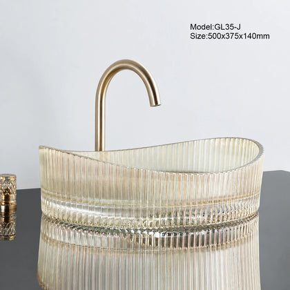 Clear gold-tinted fluted oval glass vessel sink with gold faucet, 500mm bathroom basin