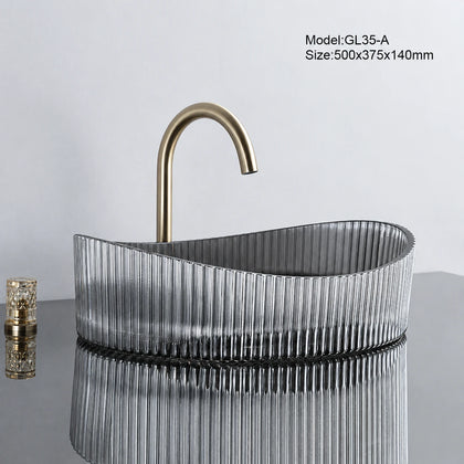 Smoke grey fluted oval glass vessel sink with gold faucet, 500mm bathroom basin