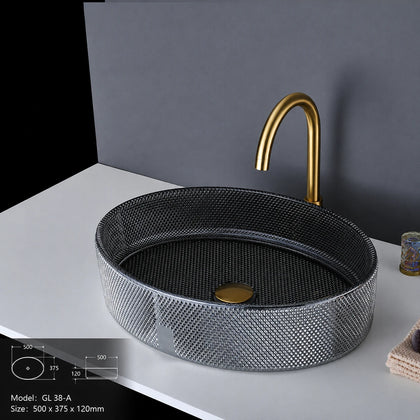 Smoke grey faceted glass vessel sink with gold faucet, oval 500mm bowl