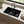 Quartz composite farmhouse apron double bowl kitchen sink installed in a styled kitchen — lifestyle scene, SANIKB SN8448D.