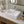 Rectangular ceramic countertop basin installed in a styled bathroom — lifestyle scene, SANIKB SN110-034.