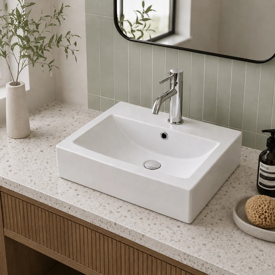 Rectangular ceramic countertop basin installed in a styled bathroom — lifestyle scene, SANIKB SN110-034.