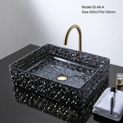 Black faceted glass vessel sink with gold faucet, rectangular 505mm basin