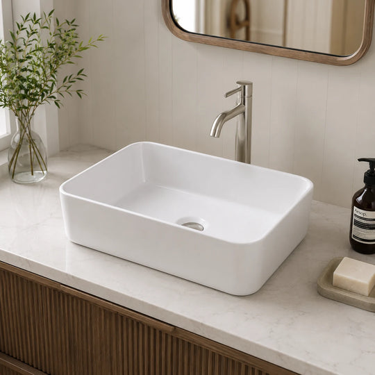 009a rounded rectangular ceramic vessel sink installed in a styled bathroom — lifestyle scene, SANIKB SN106-009A.