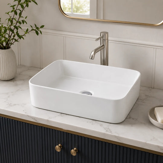 Rounded rectangular ceramic vessel sink installed in a styled bathroom — lifestyle scene, SANIKB SN167.