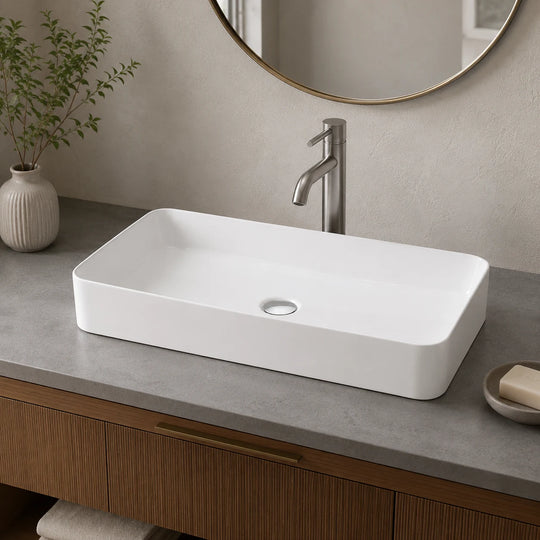 Slim rectangular ceramic vessel sink installed in a styled bathroom — lifestyle scene, SANIKB SN174.