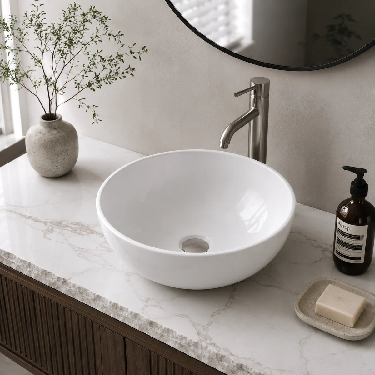 Small round ceramic vessel sink installed in a styled bathroom — lifestyle scene, SANIKB SN129.